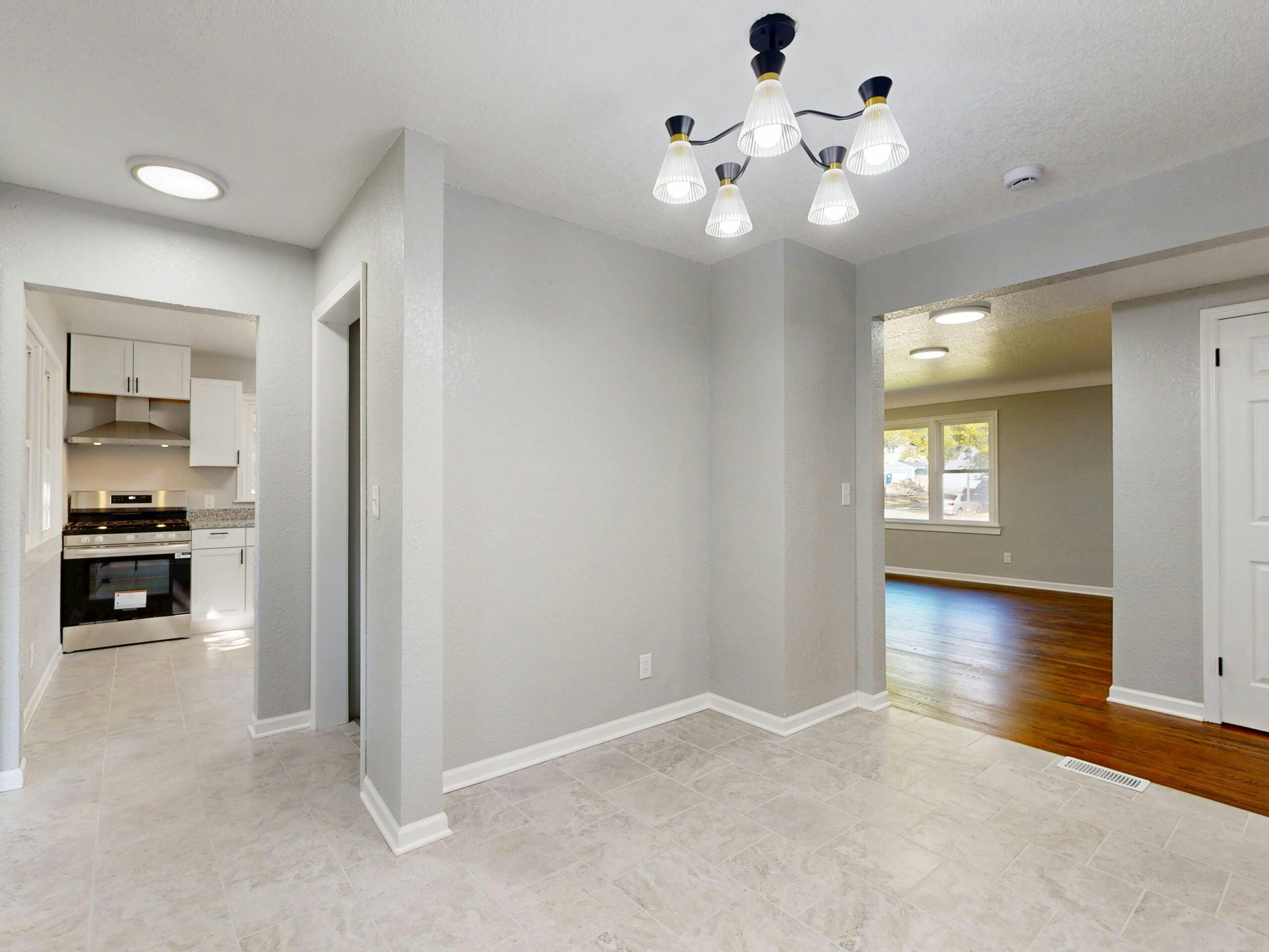 Bright and stylishly renovated home interior featuring modern lighting and open spaces.